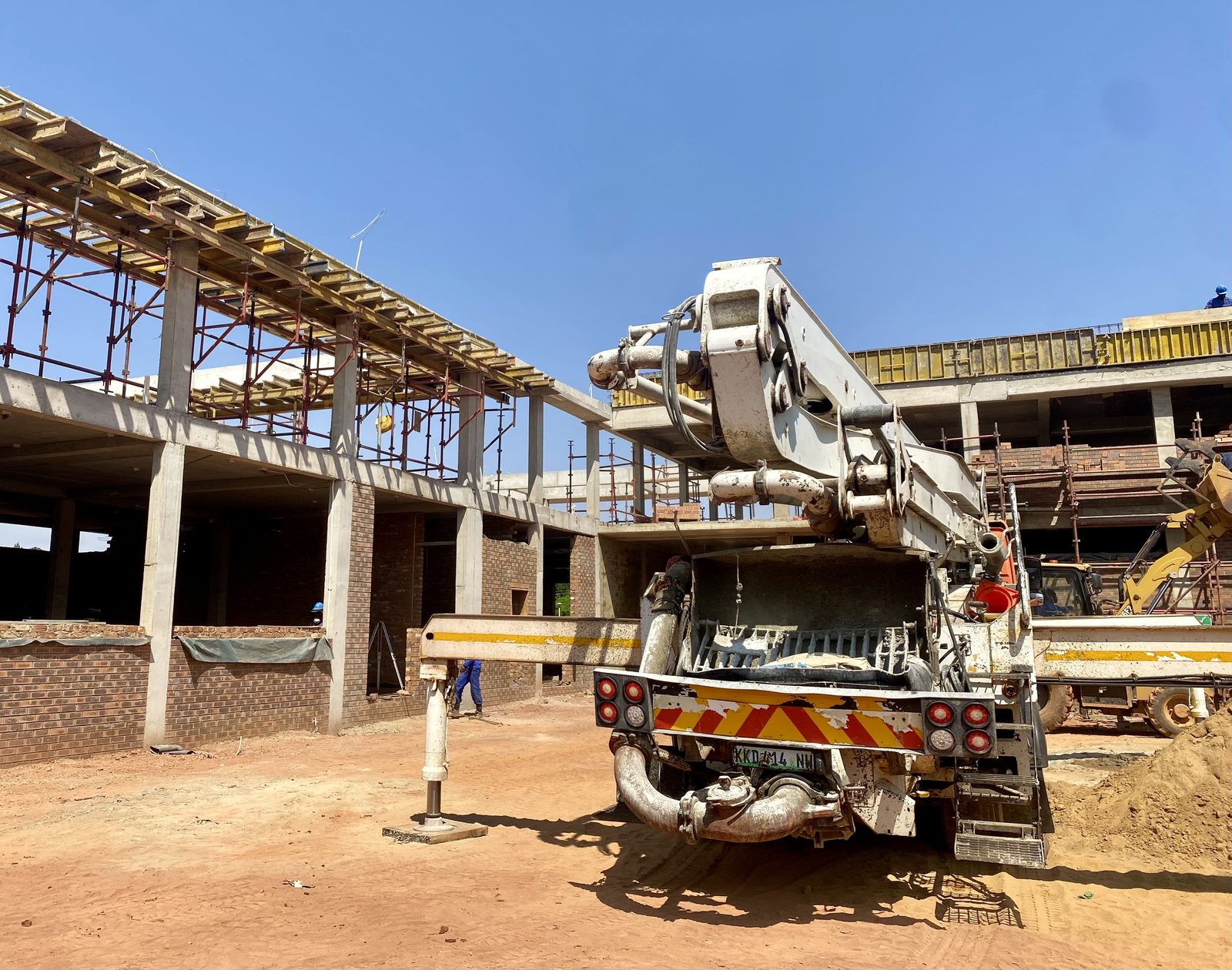 Construction of a public facility in progress, with a concrete pump on site